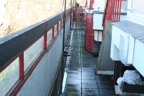 Water floods the gutters and gathers on the balconies of the top floor. There have been complaints of damp by residents below